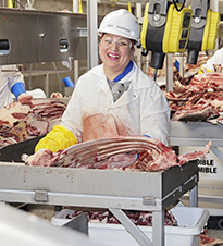 woman working with raw meat 